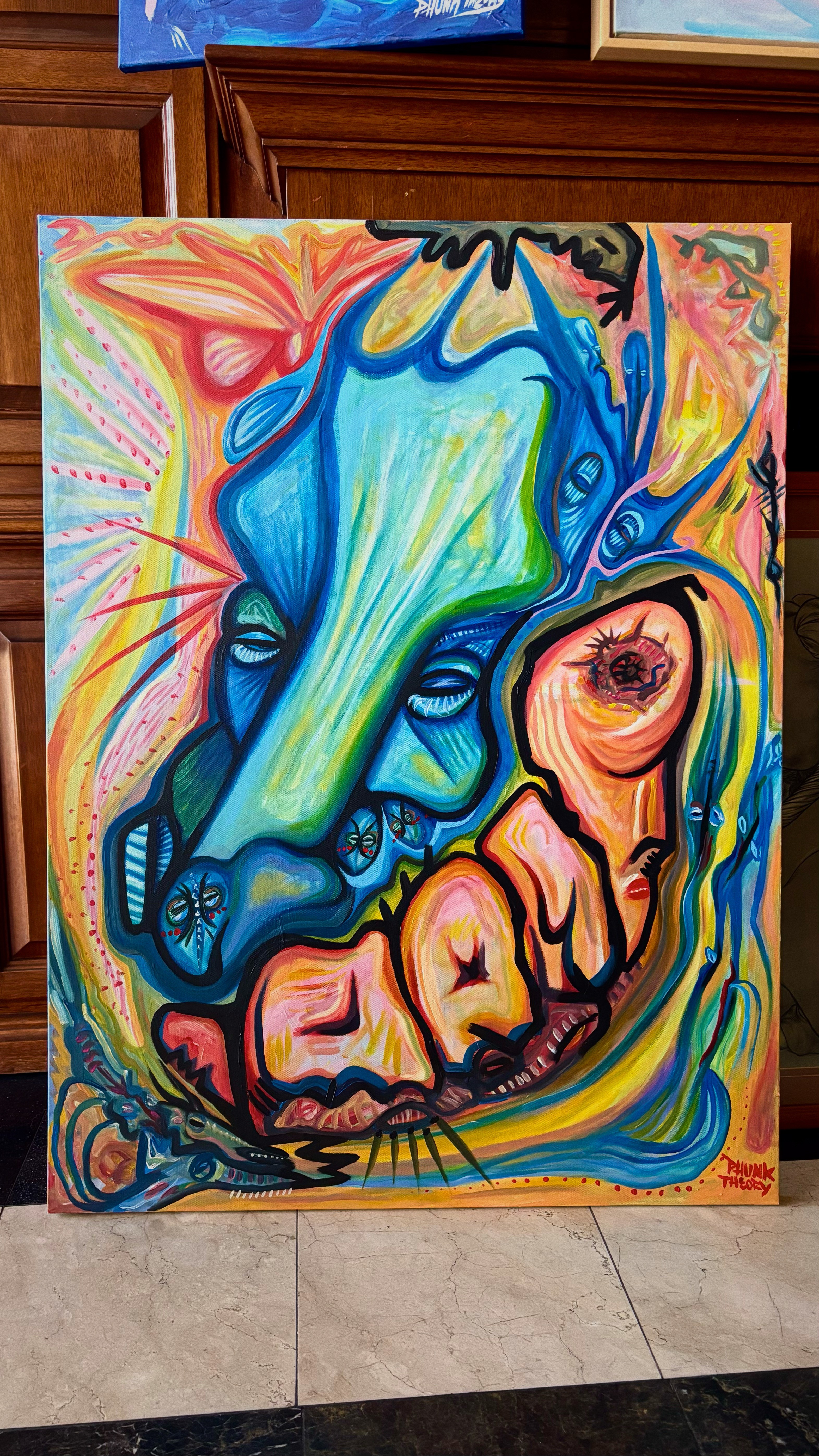 Colorful abstract painting of a face with exaggerated features and vibrant swirling background.
