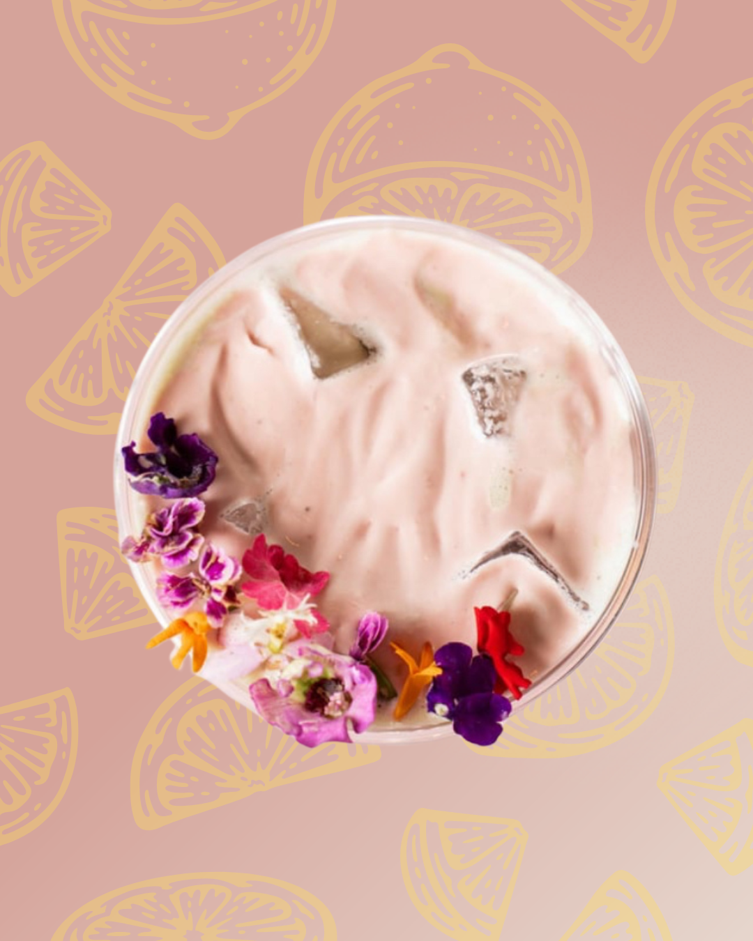A glass of pink beverage with ice and colorful flower garnishes on a pink background with lemon slice illustrations.